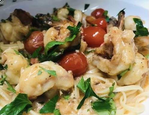 Shrimp Louisa over linguine.
